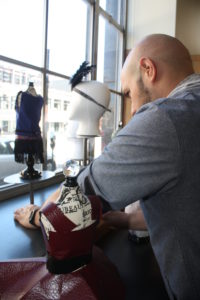 A window display designer setting up a display at Providence Public Library