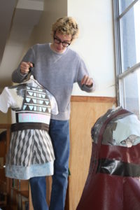 A window display designer setting up a display at Providence Public Library