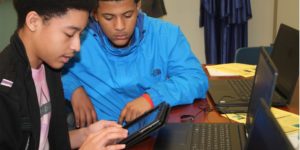 Two teenagers using a computer in a PPL education program