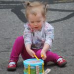 A child plays in the street during Bands on the Block