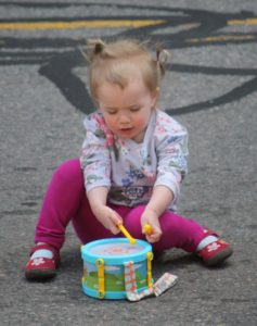A child plays in the street during Bands on the Block