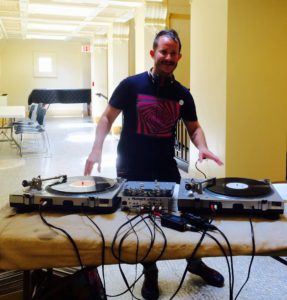 Library Director jack martin DJs at the Rock and Roll Yard Sale at Providence Public library
