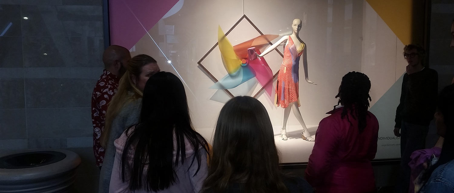 Teen Squad members look at a window display at Nordstrom