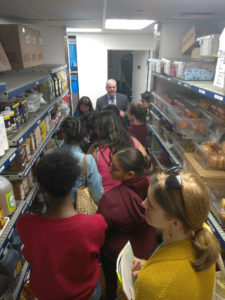 Teens getting a tour of a kitchen as part of a Teen Squad culinary arts program