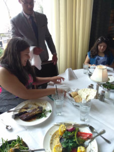 A Teen Squad participant talks to a waiter at the Genesis Center