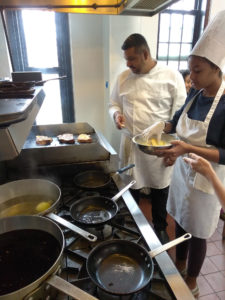 Teen Squad member making french toast in a kitchen