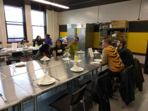 Teen Squad members sitting at a dining table with Providence Public Library Executive Directory Jack Martin