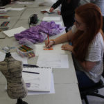 A Teen Squad member sketches a flapper style dress