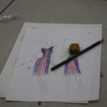 A sketch of a flapper style dress with a sketching pencil and an eraser on top of it