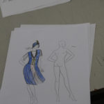 A sketch of a blue and yellow 1920s flapper style dress