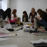 Teen Squad members constructing 1920s style dresses alongside a mentor