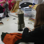 Teen Squad members work on miniature dress forms