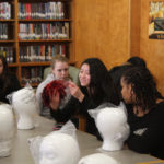 Teen Squad members working on a headdress