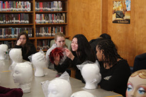 Teen Squad members working on a headdress