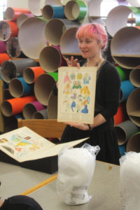 Angela DiVeglia, from Providence Public Library Special Collections, displays historic illustrations of 1920s dress