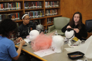 Teen Squad members working on their headdresses