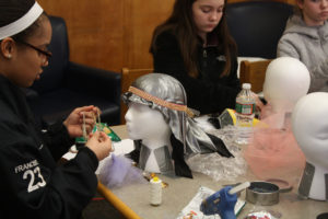 Teen Squad members working on their headdresses