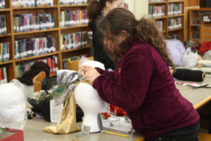 Teen Squad members working on their headdresses