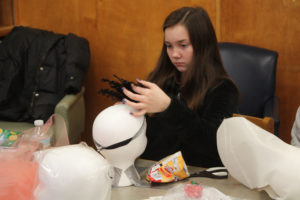 Teen Squad members working on their headdresses