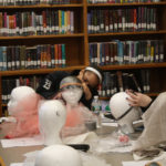 Teen Squad members working on their headdresses