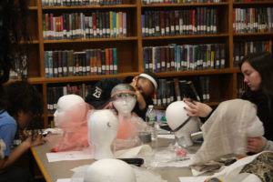 Teen Squad members working on their headdresses