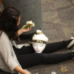 A Teen Squad member decorates a headdress