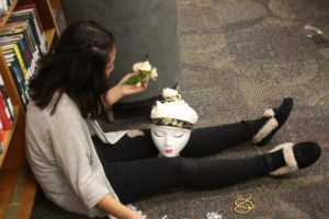 A Teen Squad member decorates a headdress