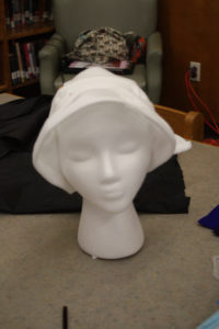 A mannequin head with a headdress form on it