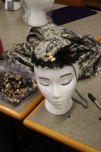 A headdress with a 1920s style flapper headdress on it