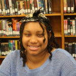 A Teen Squad participant wearing a headdress she made