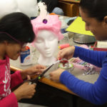 Teen Squad members cut material used to decorate a turban