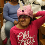 A Teen Squad member wearing a headdress she made as part of the Teen Squad program