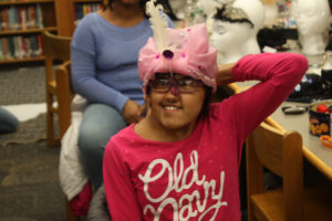 A Teen Squad member wearing a headdress she made as part of the Teen Squad program