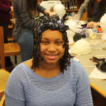 A Teen Squad member wearing a black headdress with violet trim