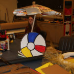 A Teen Squad member prepares a window display