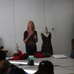 A mentor discusses dressmaking as part of a Teen Squad program