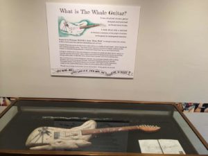 The Whale Guitar in an exhibition case.