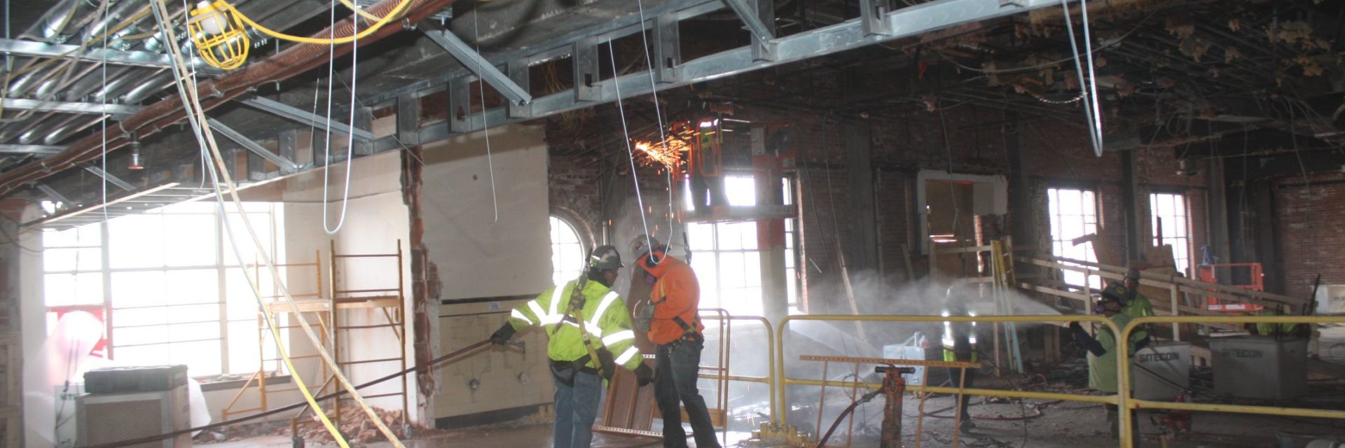 Jackhammering for 3-story Atrium Stair