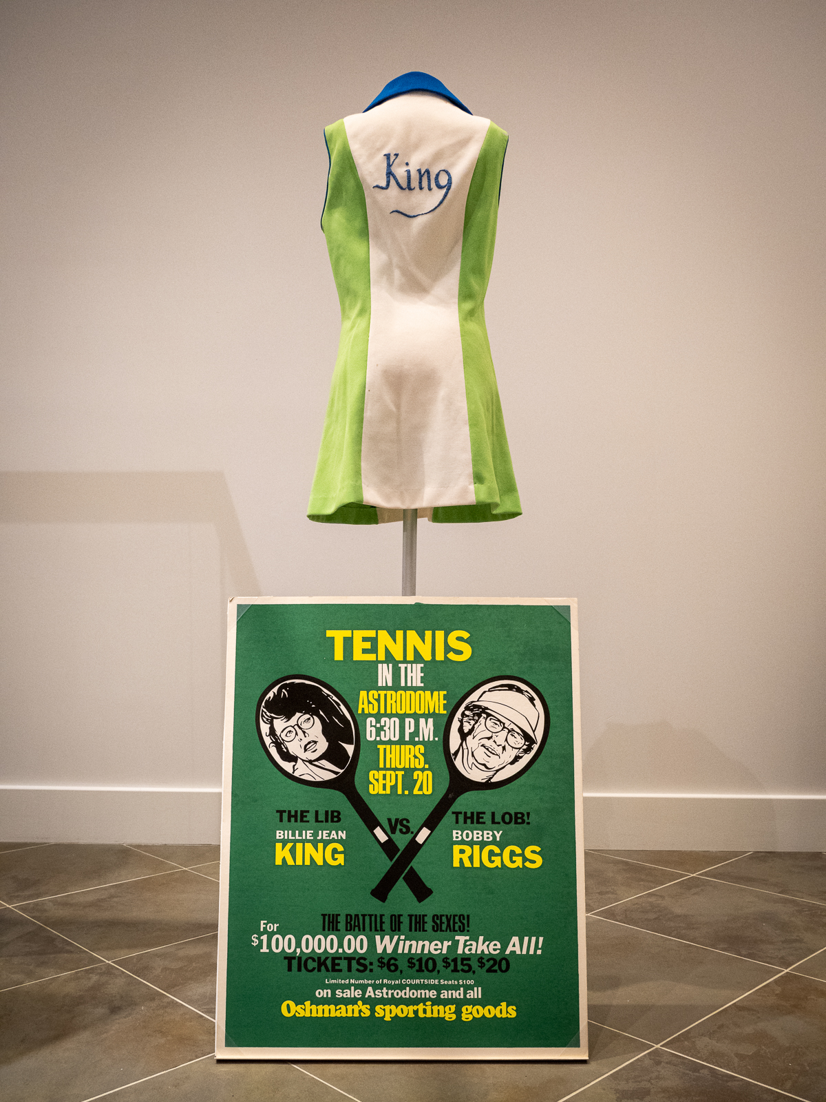 WorldTeam Tennis dress worn by Billie Jean King in 1974. On loan from the International Tennis Hall of Fame Museum.Poster advertising the “Battle of the Sexes” between Billie Jean King and Bobby Riggs, 1973.